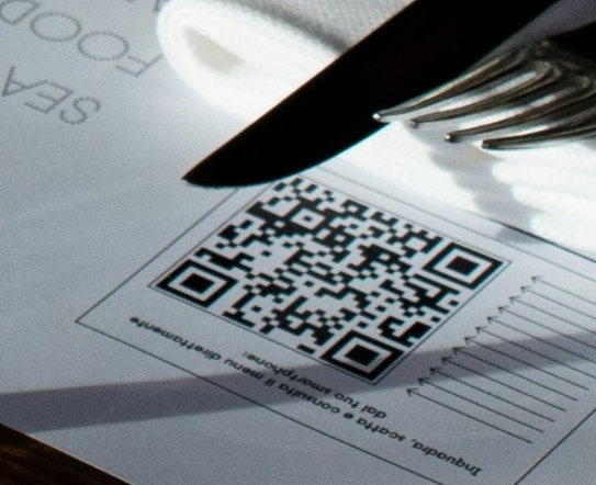 Image of a qr code where a shadow covers part of the upper-left finder pattern